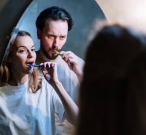 couple brushing their teeth